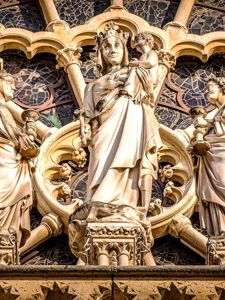 Notre-Dame Cathedral facade statues in Paris, featuring religious figures.