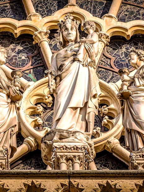Notre-Dame Cathedral facade statues in Paris, featuring religious figures.