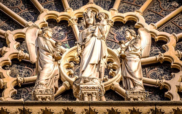 Notre-Dame Cathedral facade statues in Paris, featuring religious figures.
