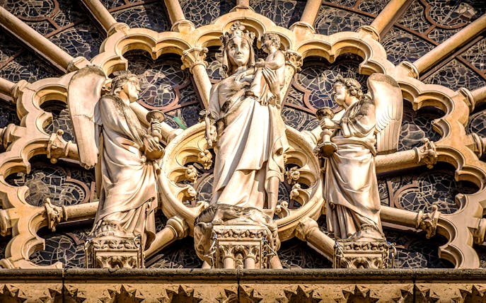 Notre-Dame Cathedral facade statues in Paris, featuring religious figures.