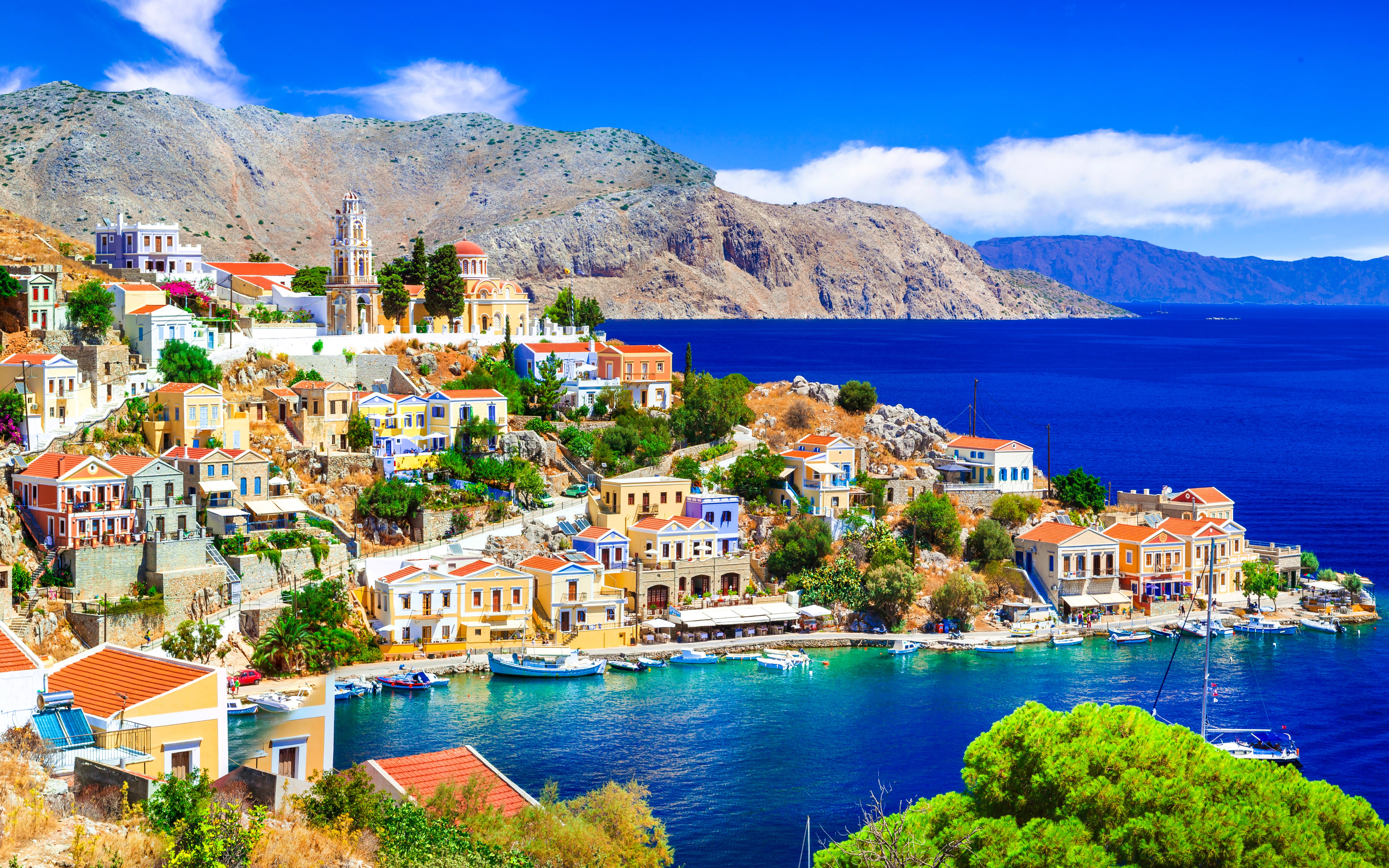Panoramic view of colorful houses and boats in Symi harbor, Rhodes.