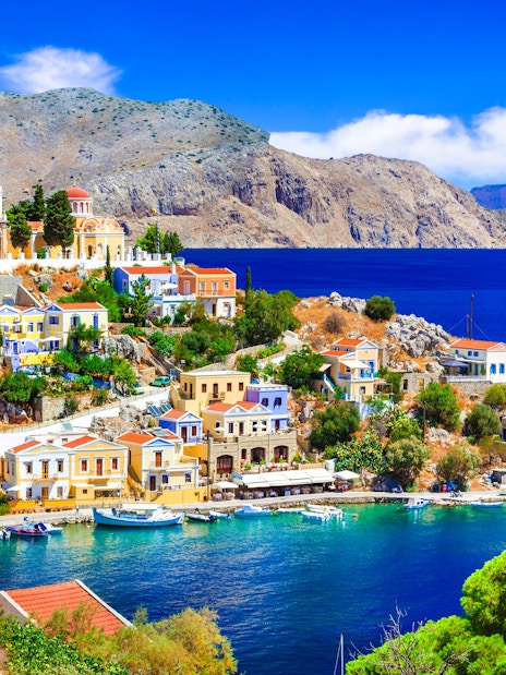 Panoramic view of colorful houses and boats in Symi harbor, Rhodes.