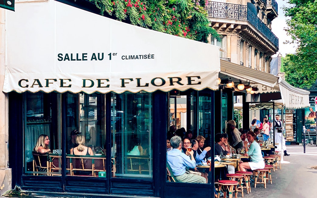 Cafe de Flore Paris, outdoor seating with people dining and conversing.