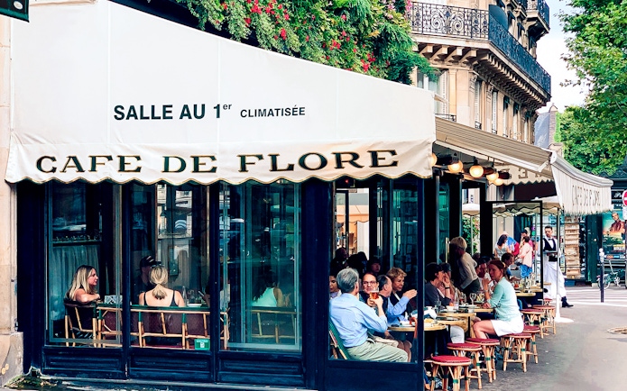 Cafe de Flore Paris, outdoor seating with people dining and conversing.