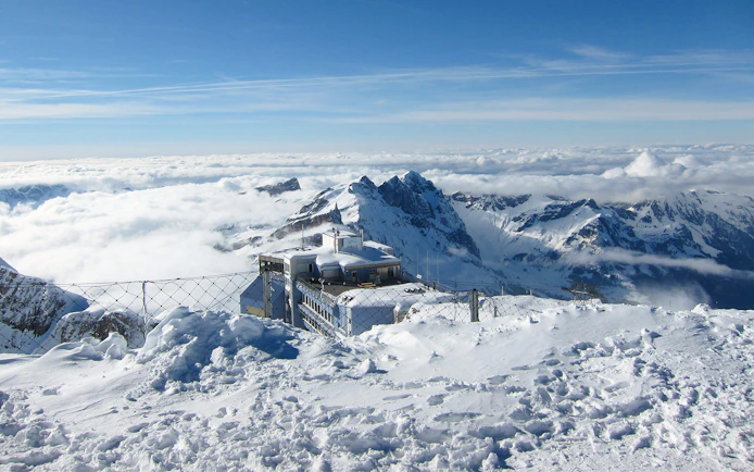Snow-covered Mount Titlis summit with panoramic views of the Swiss Alps on a guided tour from Lucerne.