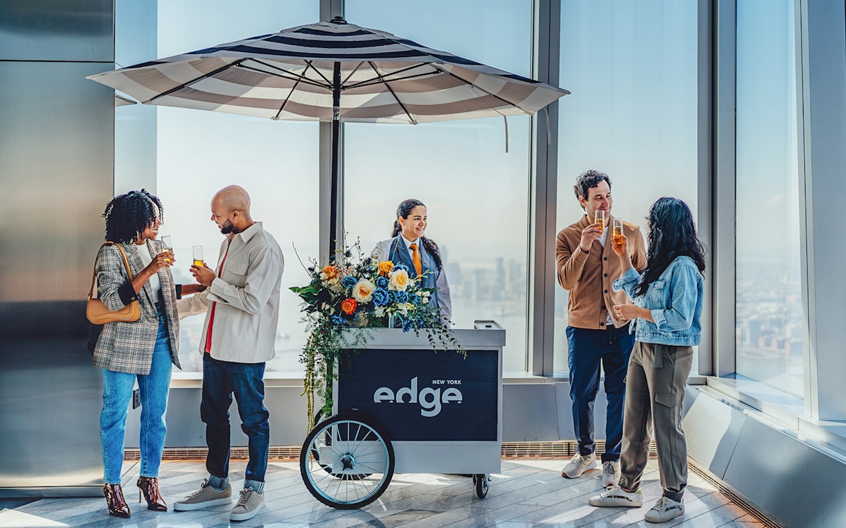 Guests enjoying drinks at the Champagne bar at Edge New York with city views.