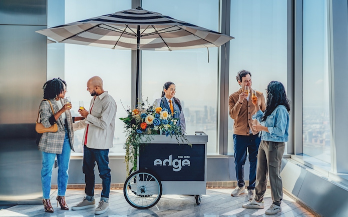 Guests enjoying drinks at the Champagne bar at Edge New York with city views.