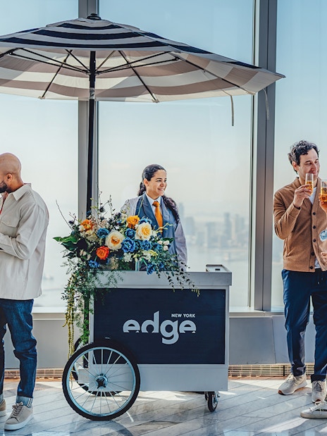 Guests enjoying drinks at the Champagne bar at Edge New York with city views.