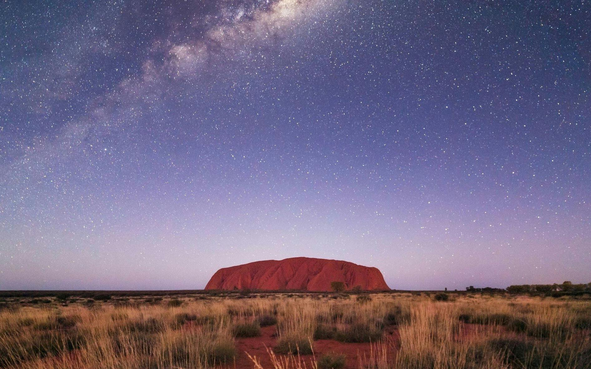 Uluru under a starry night sky during the Outback Camping Adventure.