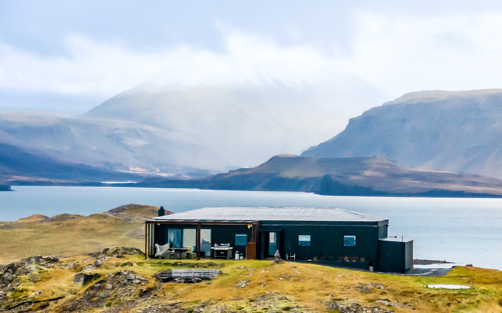 Aerial view of Hvalfjörður, Hvammsvik with distinctive black houses in Iceland.