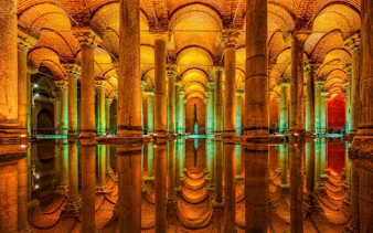 Basilica Cistern's illuminated columns reflecting in water, Istanbul.