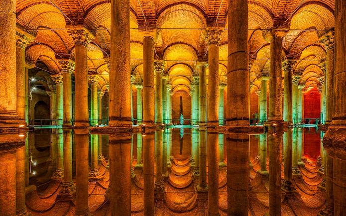 Basilica Cistern's illuminated columns reflecting in water, Istanbul.