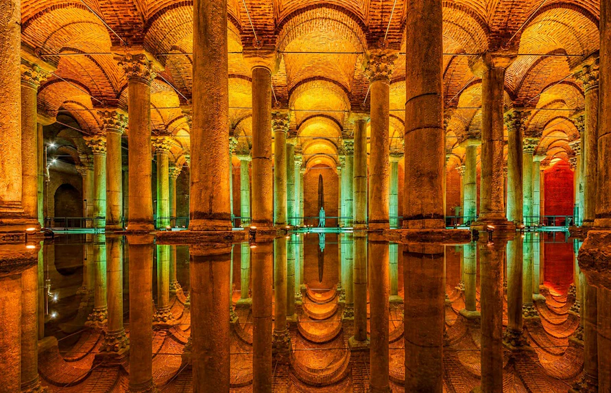 Basilica Cistern's illuminated columns reflecting in water, Istanbul.