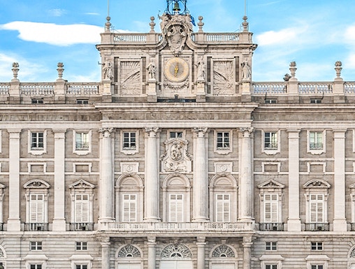 Royal Palace of Madrid facade with Spanish flag, Madrid, Spain.