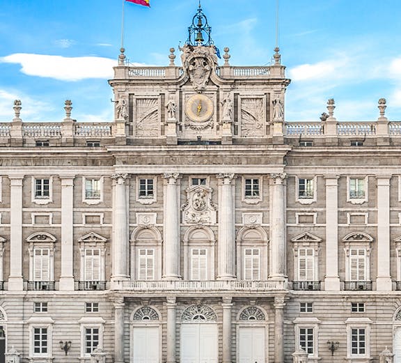 Royal Palace of Madrid facade with Spanish flag, Madrid, Spain.