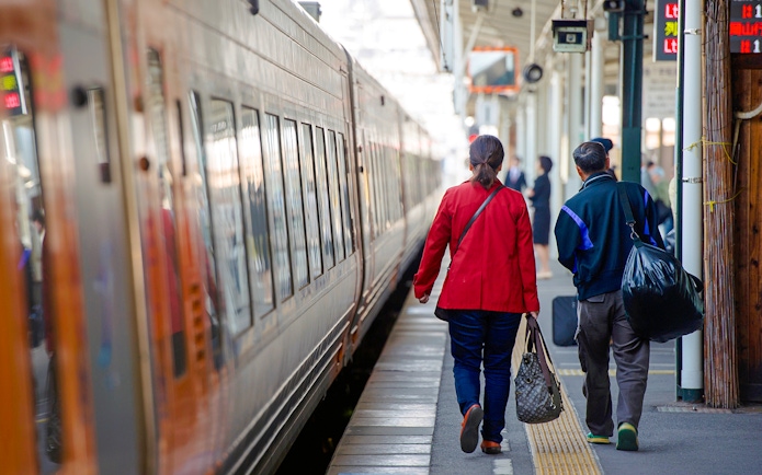Couple walking on a train platform in Japan.