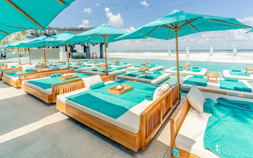 Poolside lounge beds at Atlas Night Club with ocean view.