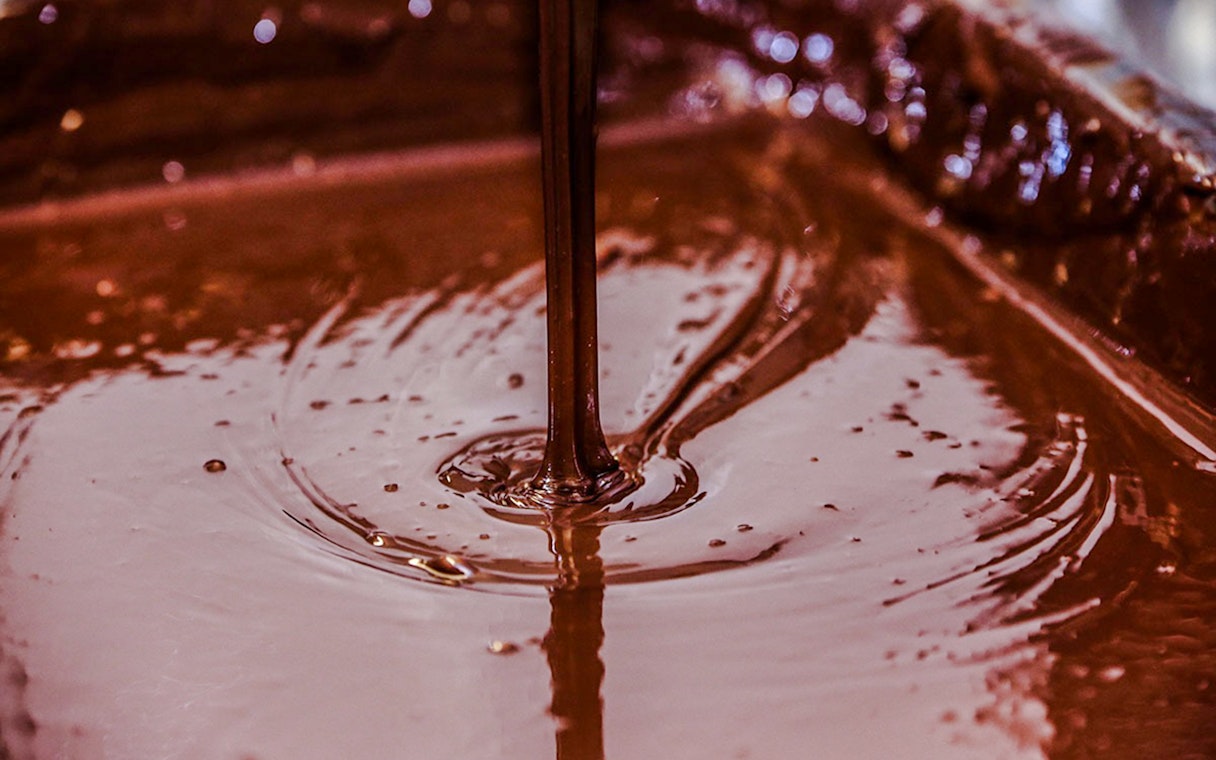 Pouring chocolate fudge at Choco-Story Brussels Museum.