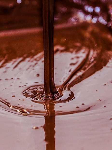Pouring chocolate fudge at Choco-Story Brussels Museum.