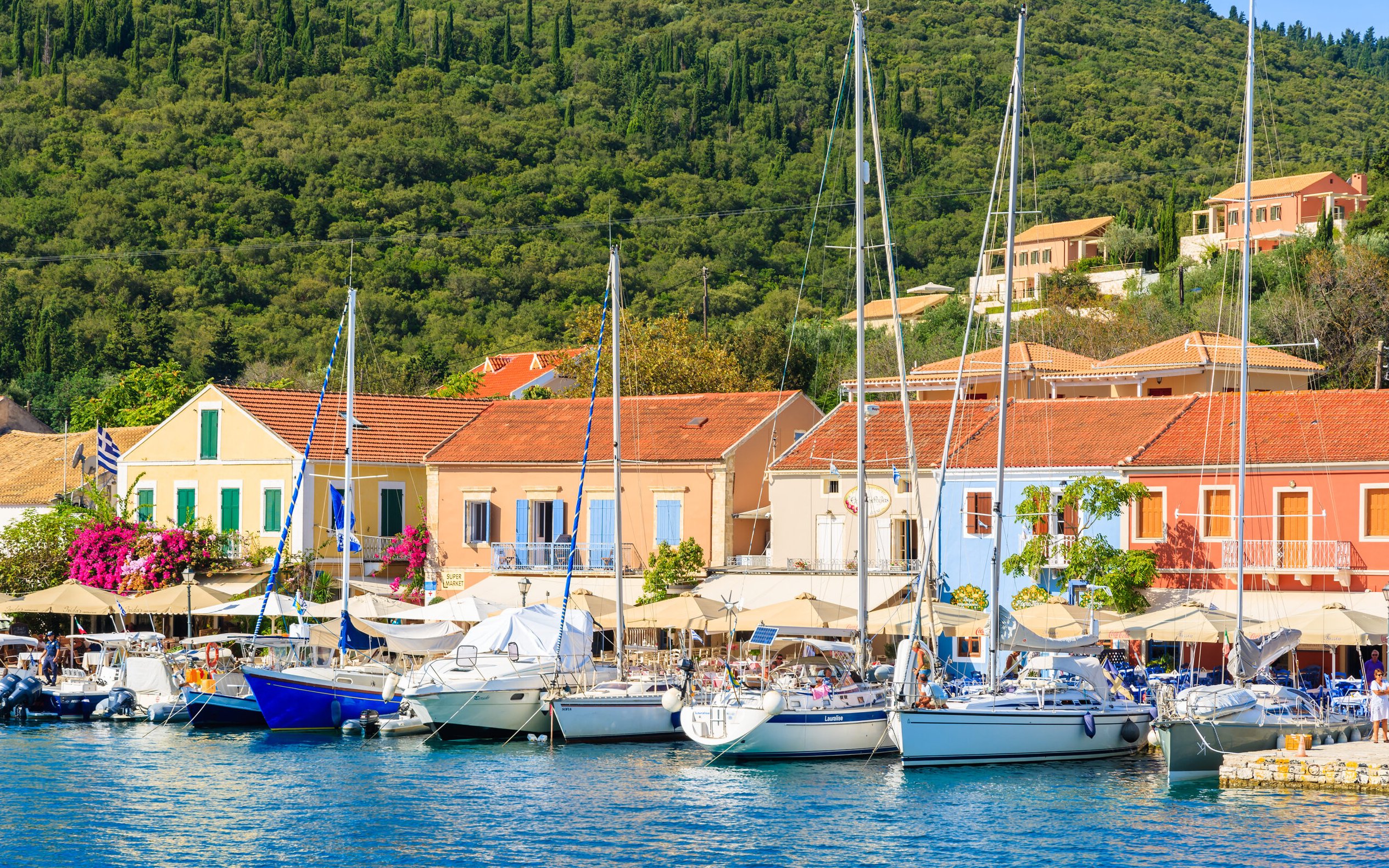 Boats docked at Fiskardo village harbor, Kefalonia island, Greece.