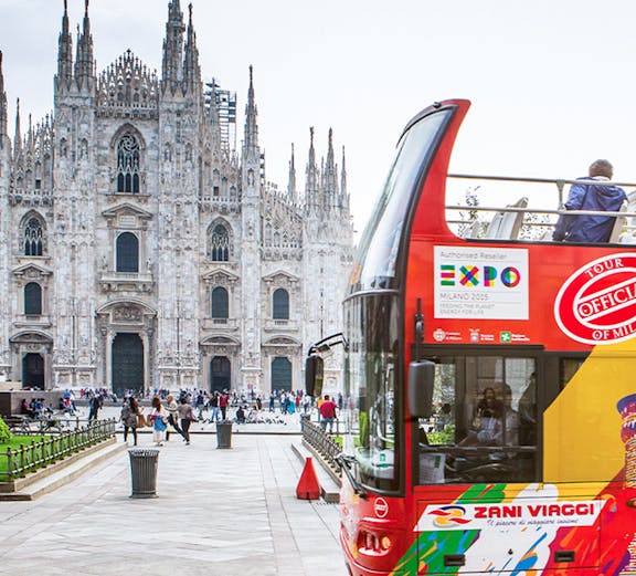 Open-top bus near Milan Cathedral on city sightseeing tour.