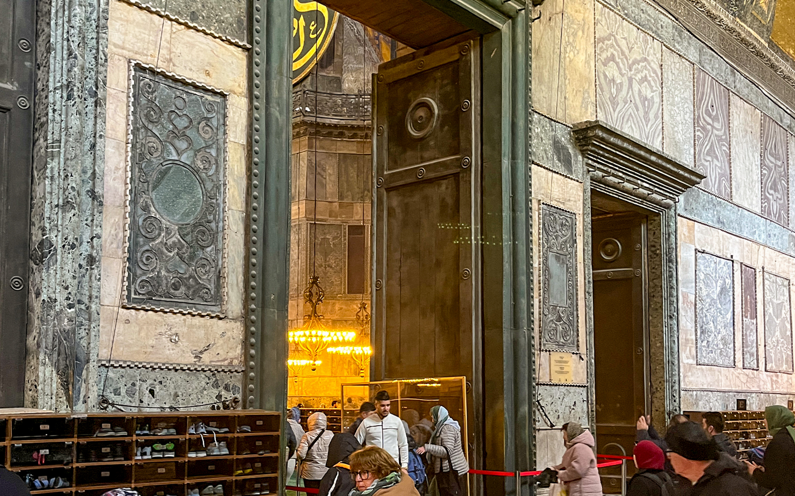Hagia Sophia imperial gate with visitors entering, Istanbul, Turkey.