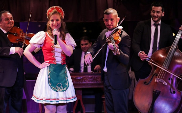 Musicians and singer performing traditional folk music on a Budapest dinner cruise.