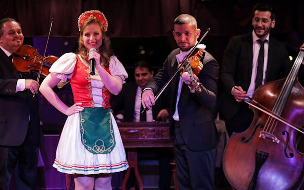Musicians and singer performing traditional folk music on a Budapest dinner cruise.