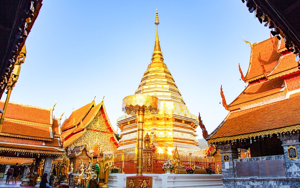 Golden stupa at Wat Phra That Doi Suthep in Chiang Mai, Thailand, surrounded by ornate temple structures.