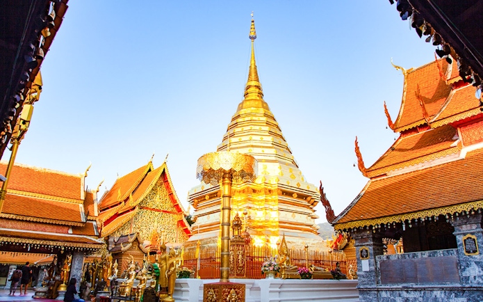 Golden stupa at Wat Phra That Doi Suthep in Chiang Mai, Thailand, surrounded by ornate temple structures.