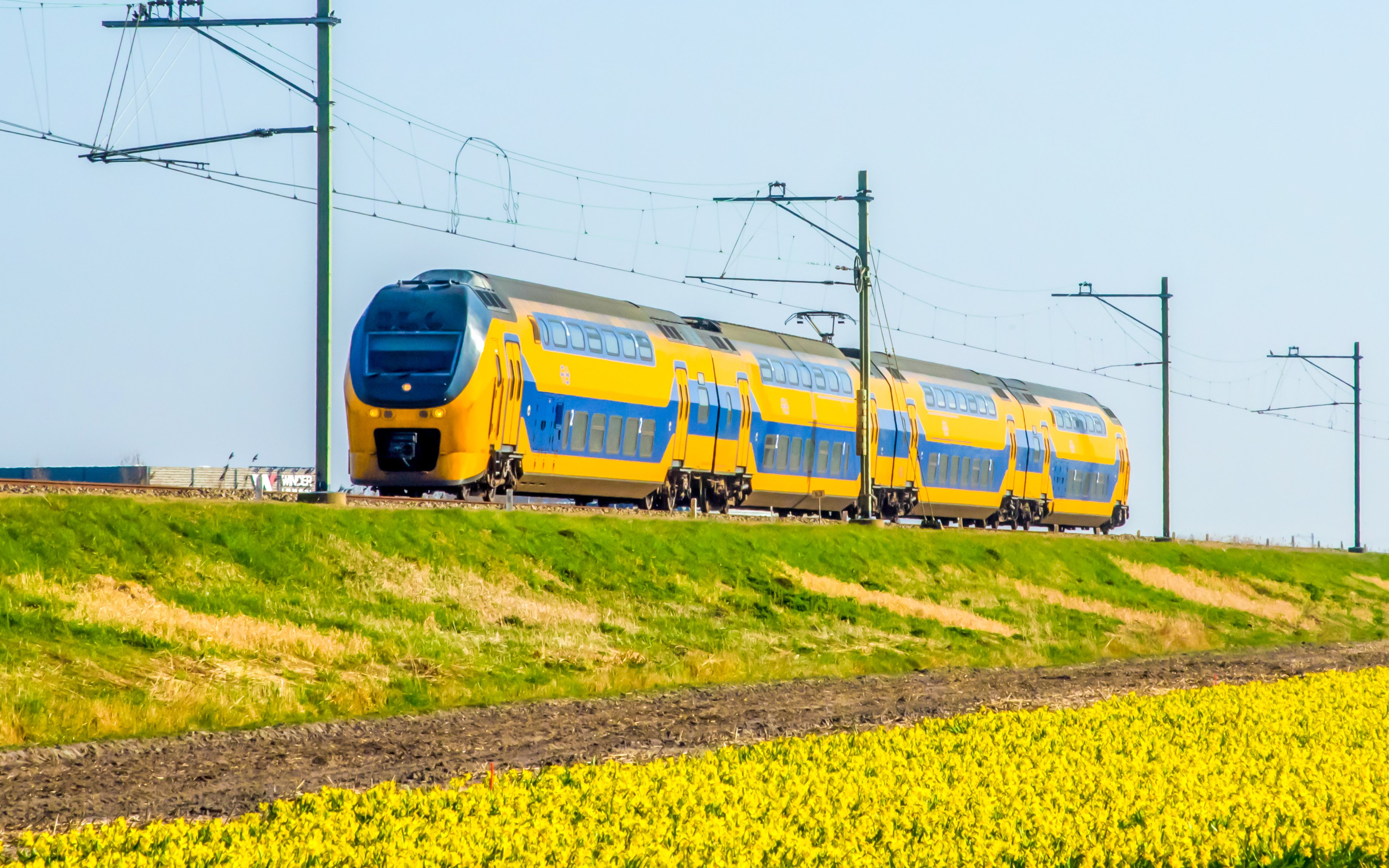 Train traveling through Dutch countryside near Amsterdam Centraal.