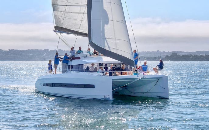 Guests on a catamaran enjoying a breakfast cruise on the water.
