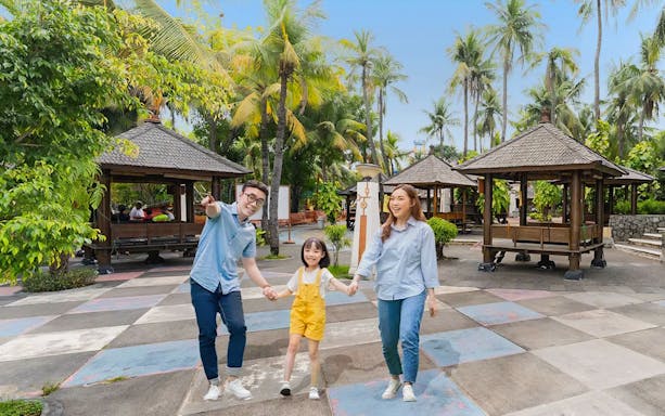 Family enjoying water slides at Ancol Atlantis Water Adventure Park, Jakarta.
