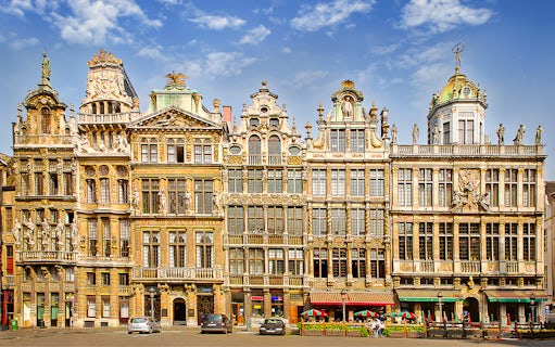 Ornate guildhalls in Brussels' Grand Place under a blue sky.