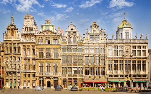 Ornate guildhalls in Brussels' Grand Place under a blue sky.