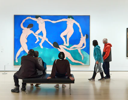 Tourists viewing modern art paintings at The Museum of Modern Art.