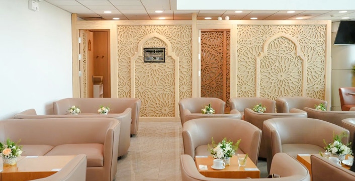 Server preparing buffet at Jasmine Halal Lounge, Terminal 2, Tan Son Nhat International Airport.