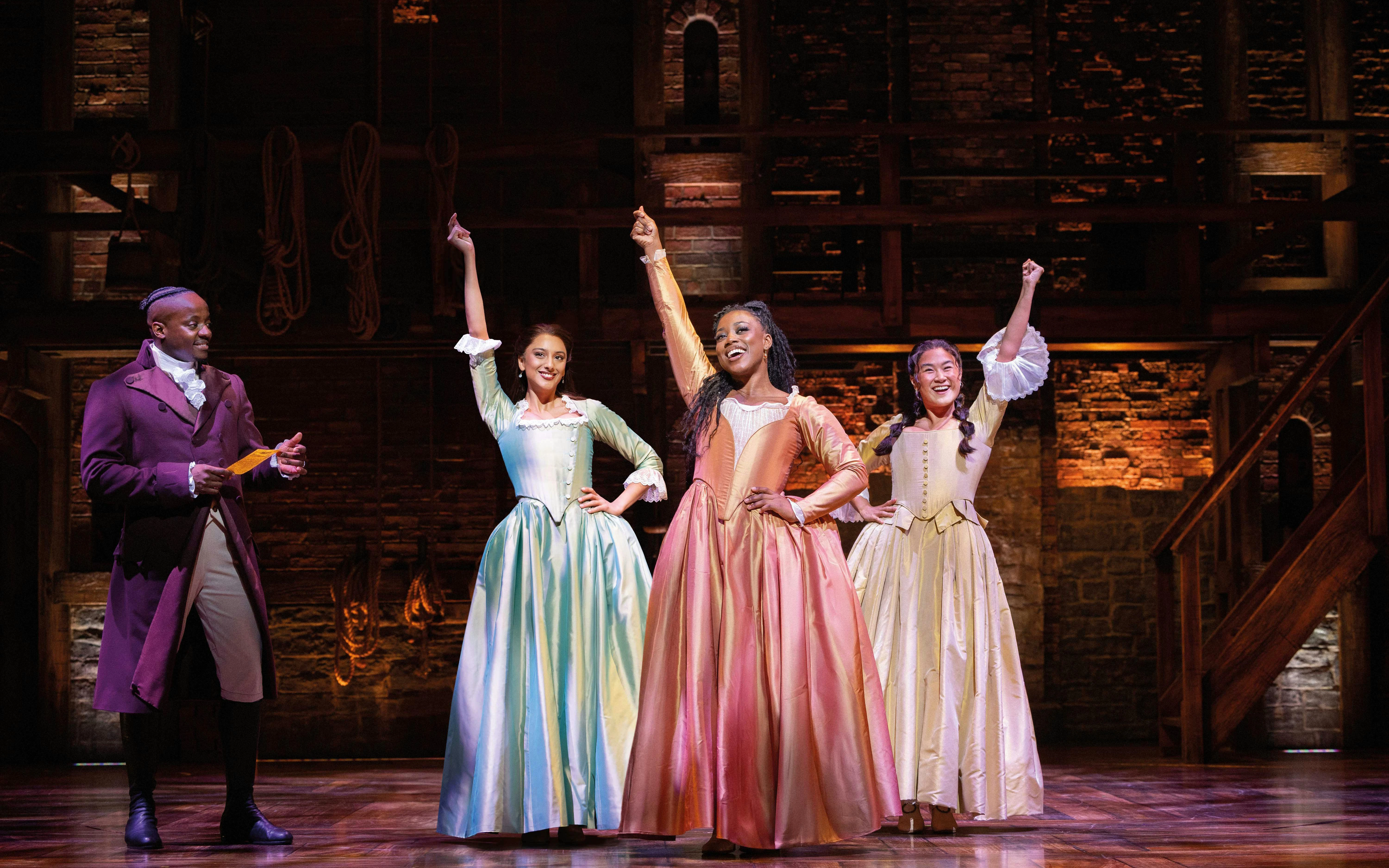 Performers on stage during Hamilton musical in West End theater.