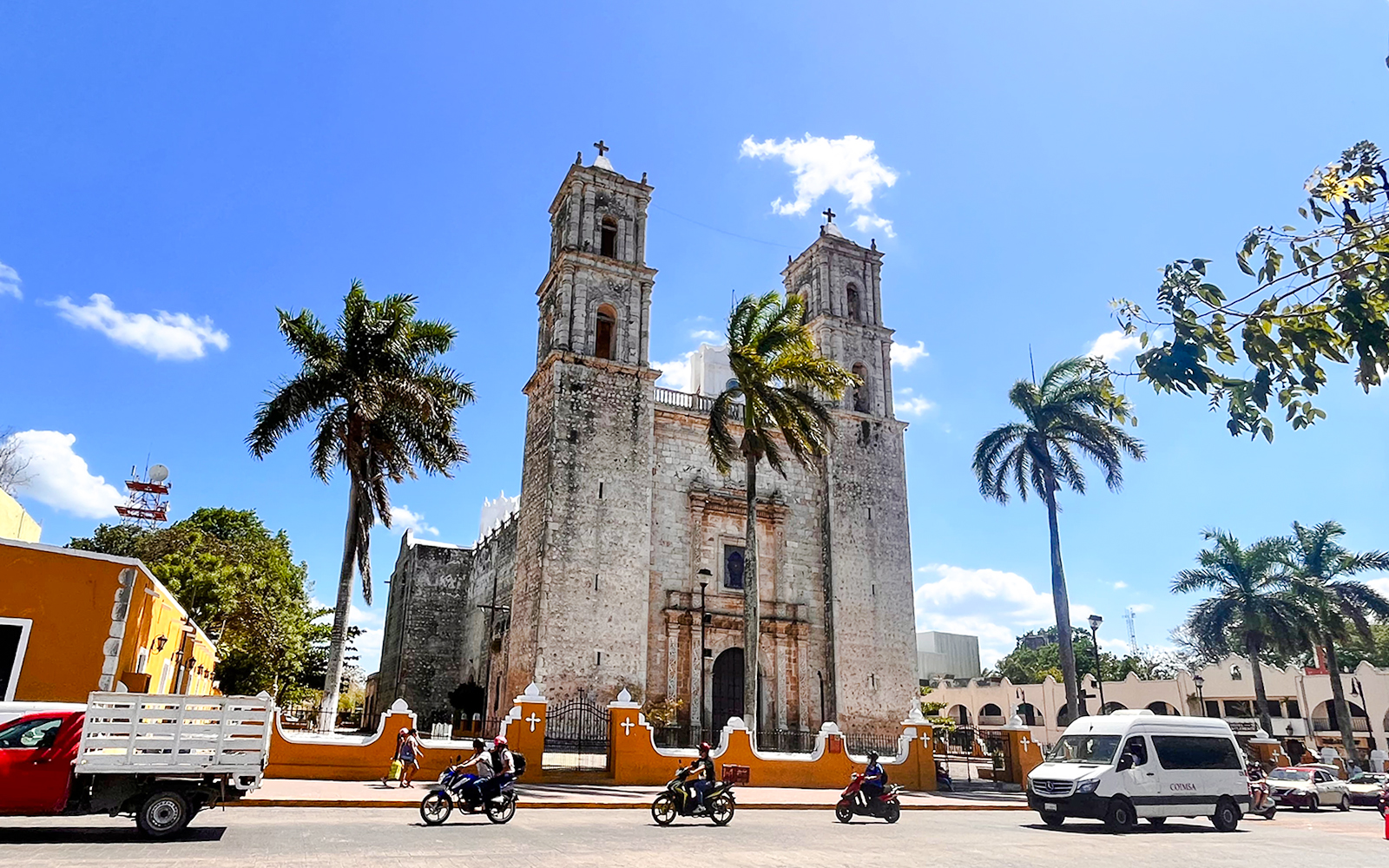 Church of San Servacio with palm trees and street in Valladolid, Yucatan, Mexico.