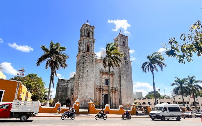 Church of San Servacio with palm trees and street in Valladolid, Yucatan, Mexico.