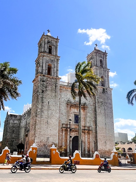 Church of San Servacio with palm trees and street in Valladolid, Yucatan, Mexico.