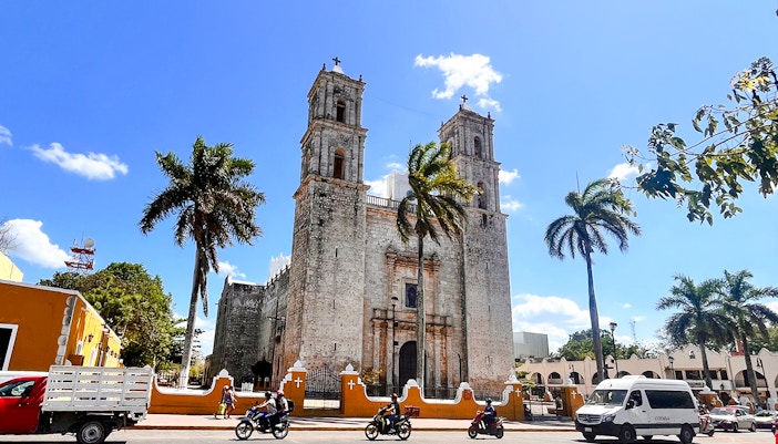 Church of San Servacio with palm trees and street in Valladolid, Yucatan, Mexico.