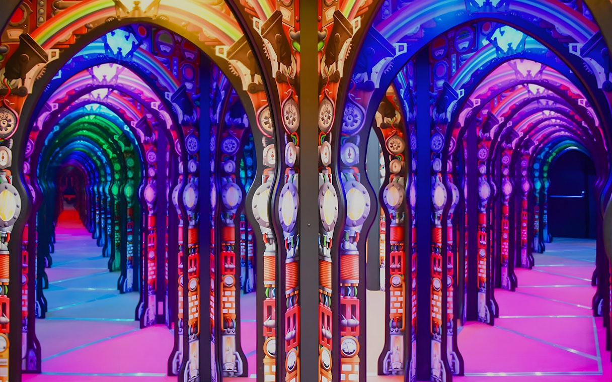 Colorful mirrored arches at Science Centre Singapore exhibit.