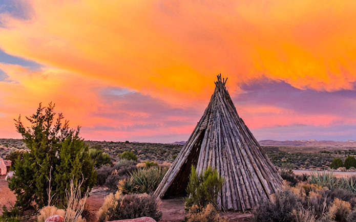 Teepee under vibrant sunset at Grand Canyon West.