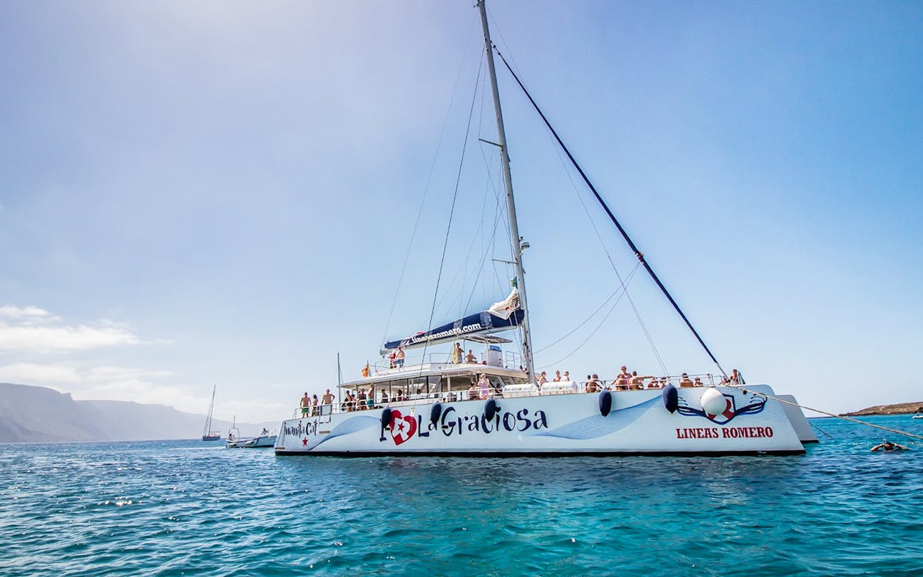 Ferry sailing from Fuerteventura to Lanzarote with passengers on deck.