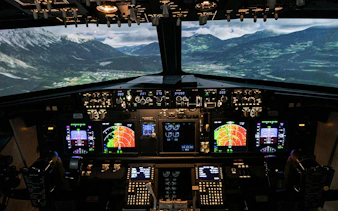 Boeing 737 flight simulator cockpit with mountain landscape view, Istanbul.