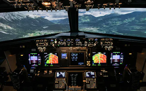 Boeing 737 flight simulator cockpit with mountain landscape view, Istanbul.