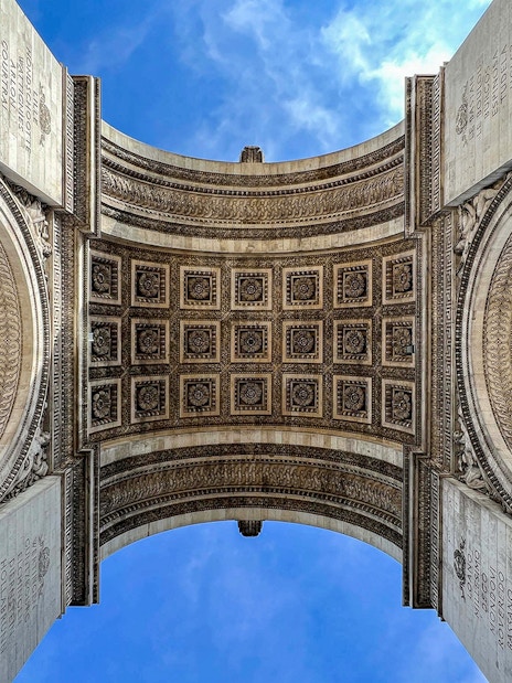 View of the Arc de Triomphe's intricate ceiling in Paris, part of an audio-guided tour.