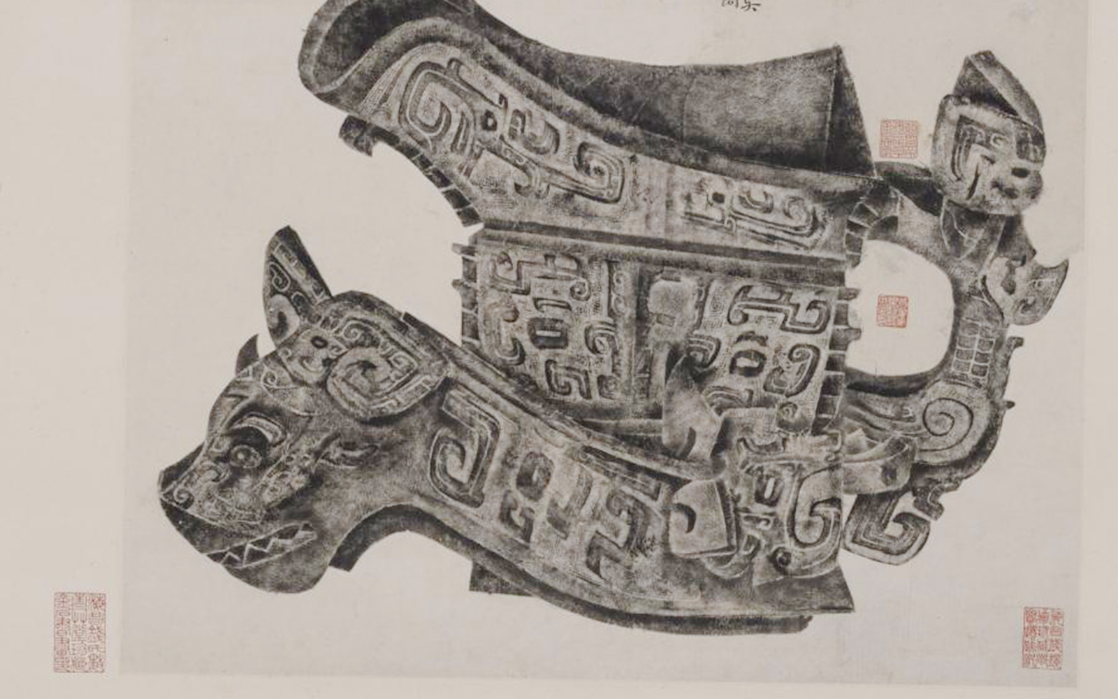 Ancient Chinese bronze vessel with intricate carvings at Cernuschi Museum, Paris exhibition.