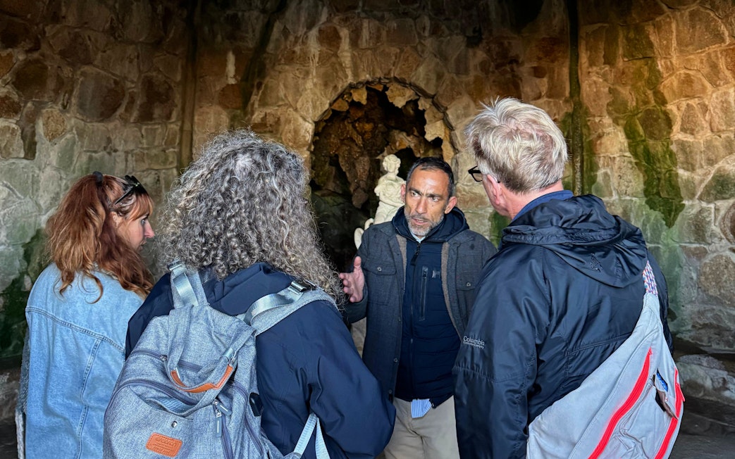 Tourists with guide inside Quinta da Regaleira's grotto, Sintra, Portugal.